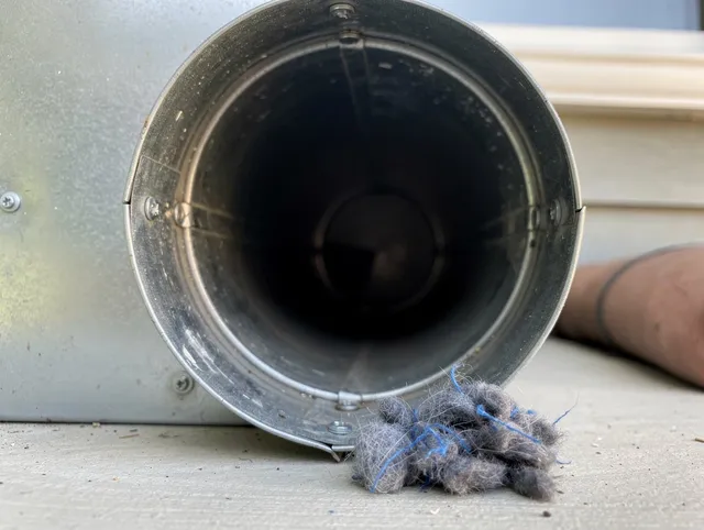 Aliso Viejo Dryer Vent Cleaning technician using specialized equipment to clear severe dryer vent blockage in Aliso Viejo